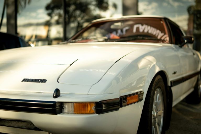 A vintage white Mazda RX-7 car photographed at a car meet in Brisbane, Australia.