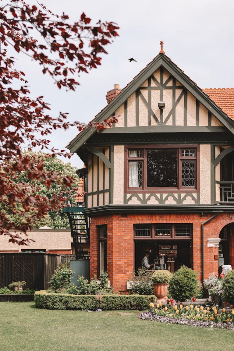 A beautiful Tudor-style house with lush gardens in Christchurch, New Zealand.