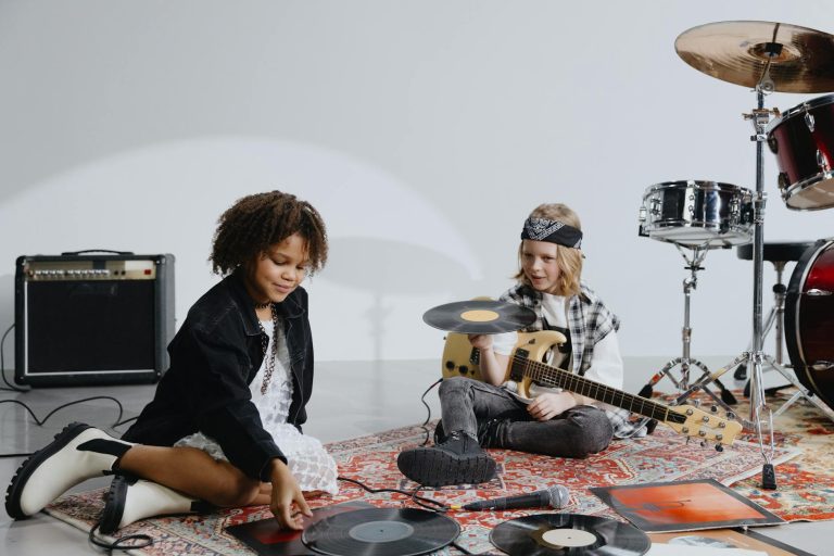 Two kids exploring musical instruments and vinyl records, enjoying a playful indoor moment.